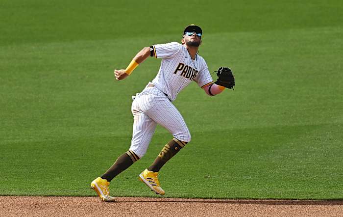 Padres’ Fernando Tatis Jr. chases a flyball into the outfield grass.